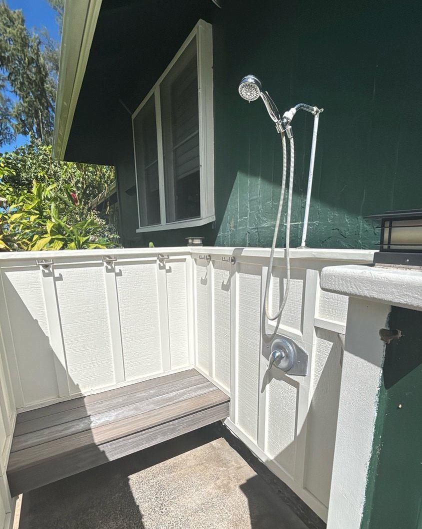 Outdoor shower has bench available