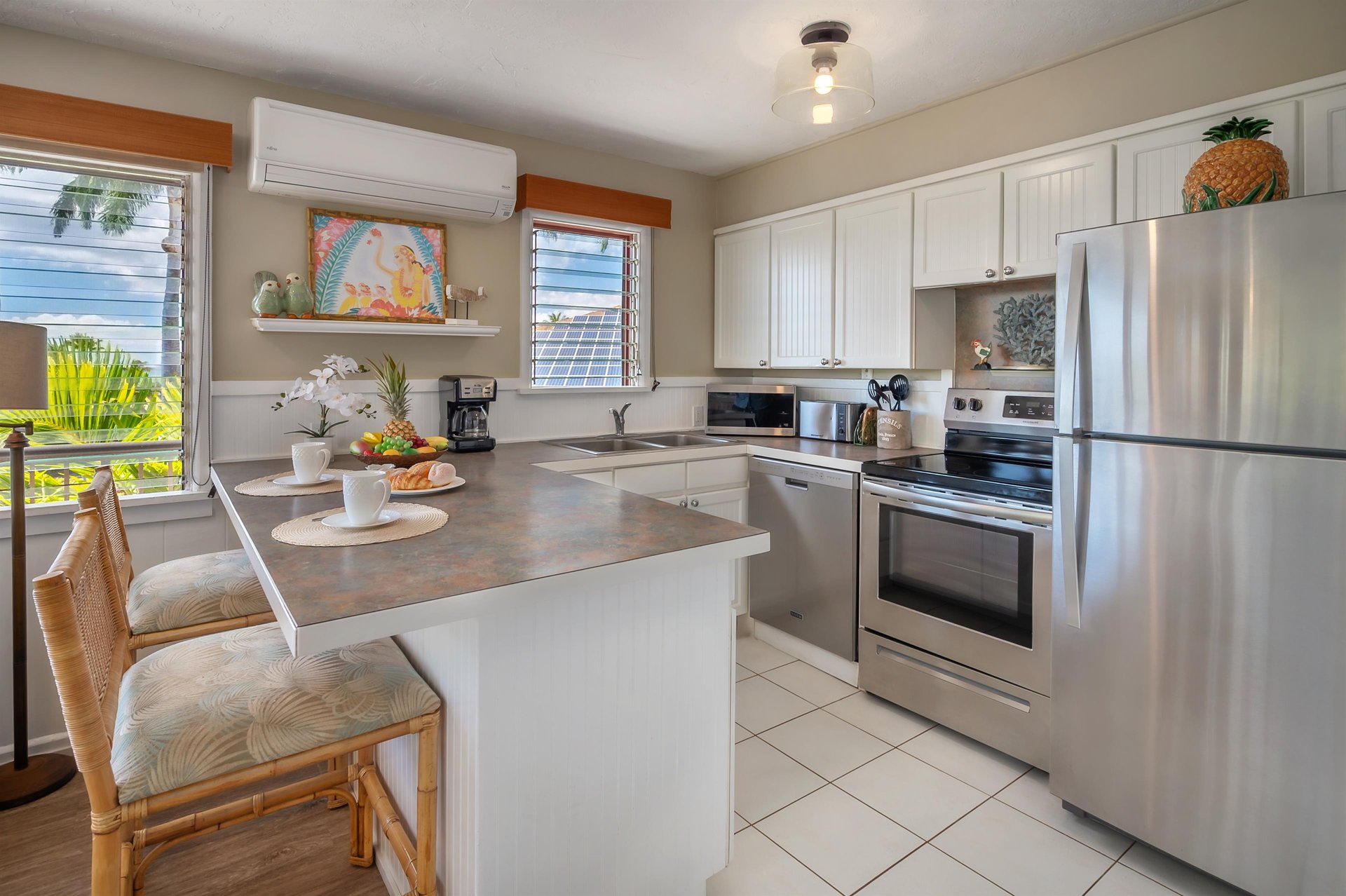 The kitchen is fully equipped and includes a bar top