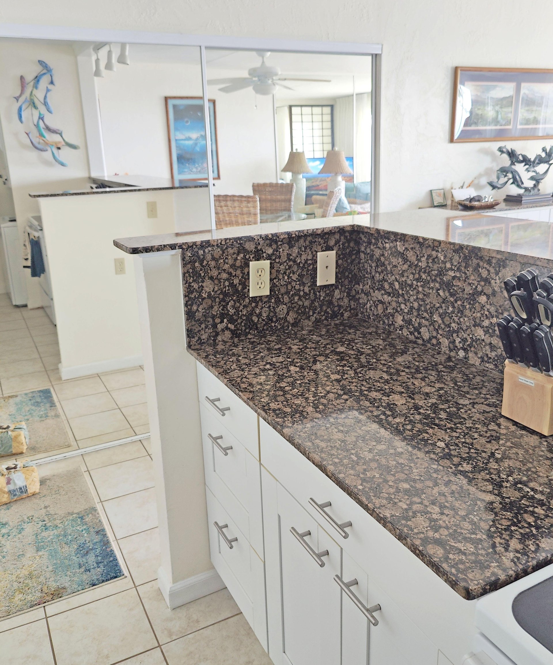 Granite topped peninsula with back to back cabinets.