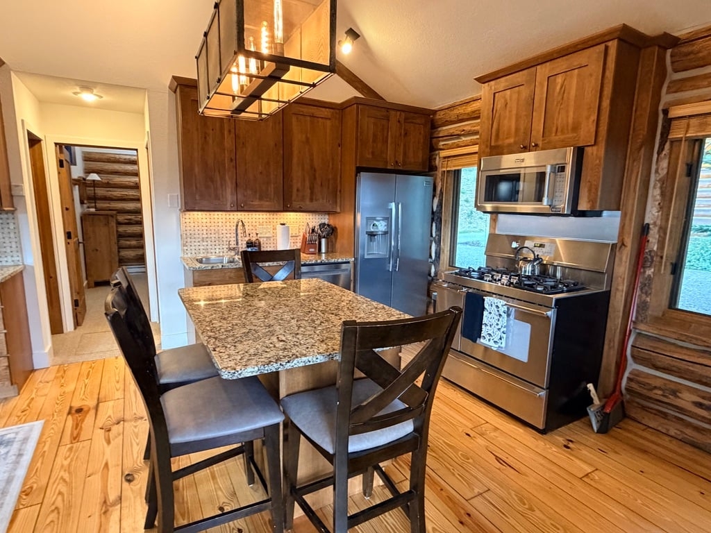 a kitchen with a table and chairs