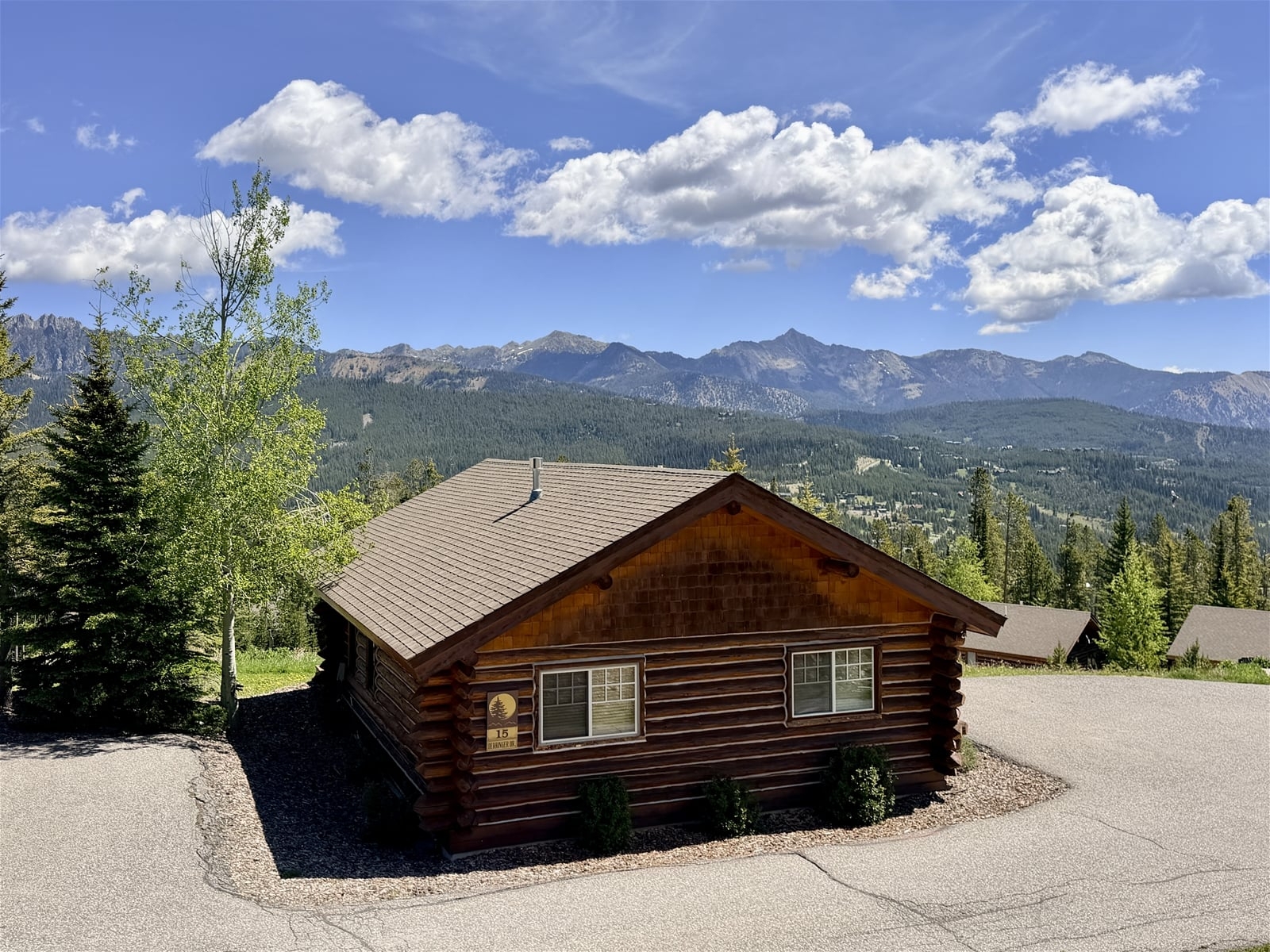 a wood house with a mountain in the background