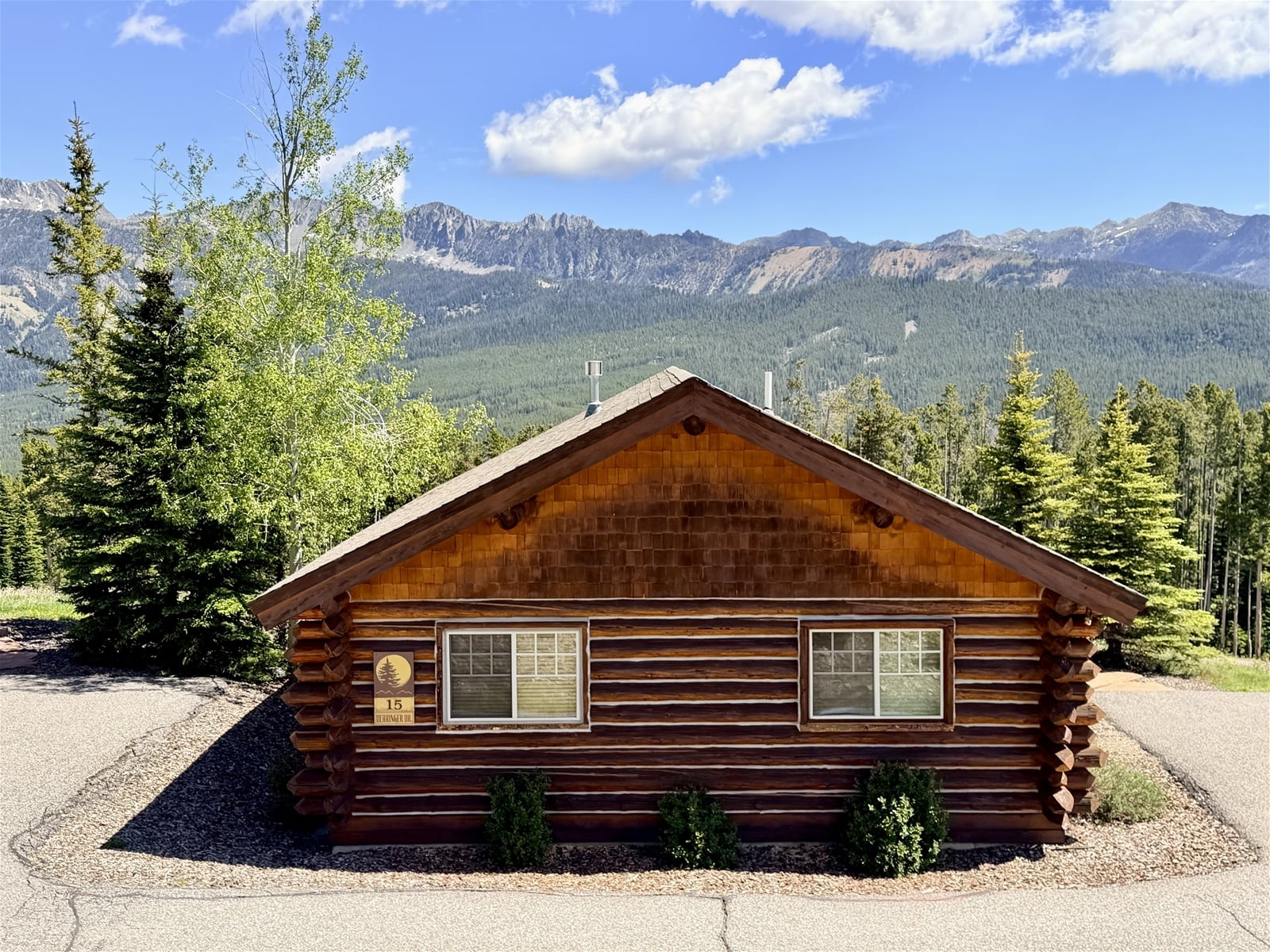a wood building with a mountain in the background
