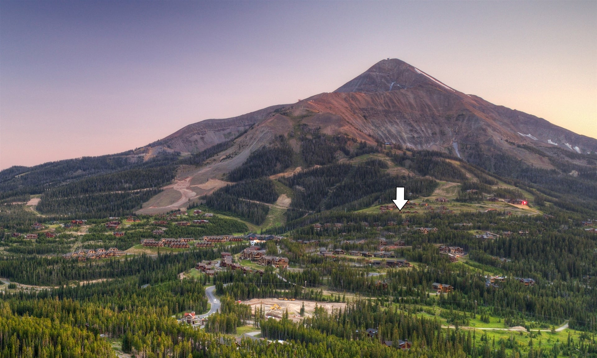 a large mountain with a town below