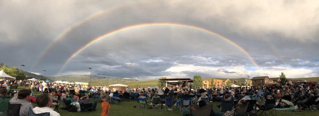 a rainbow over a crowd of people