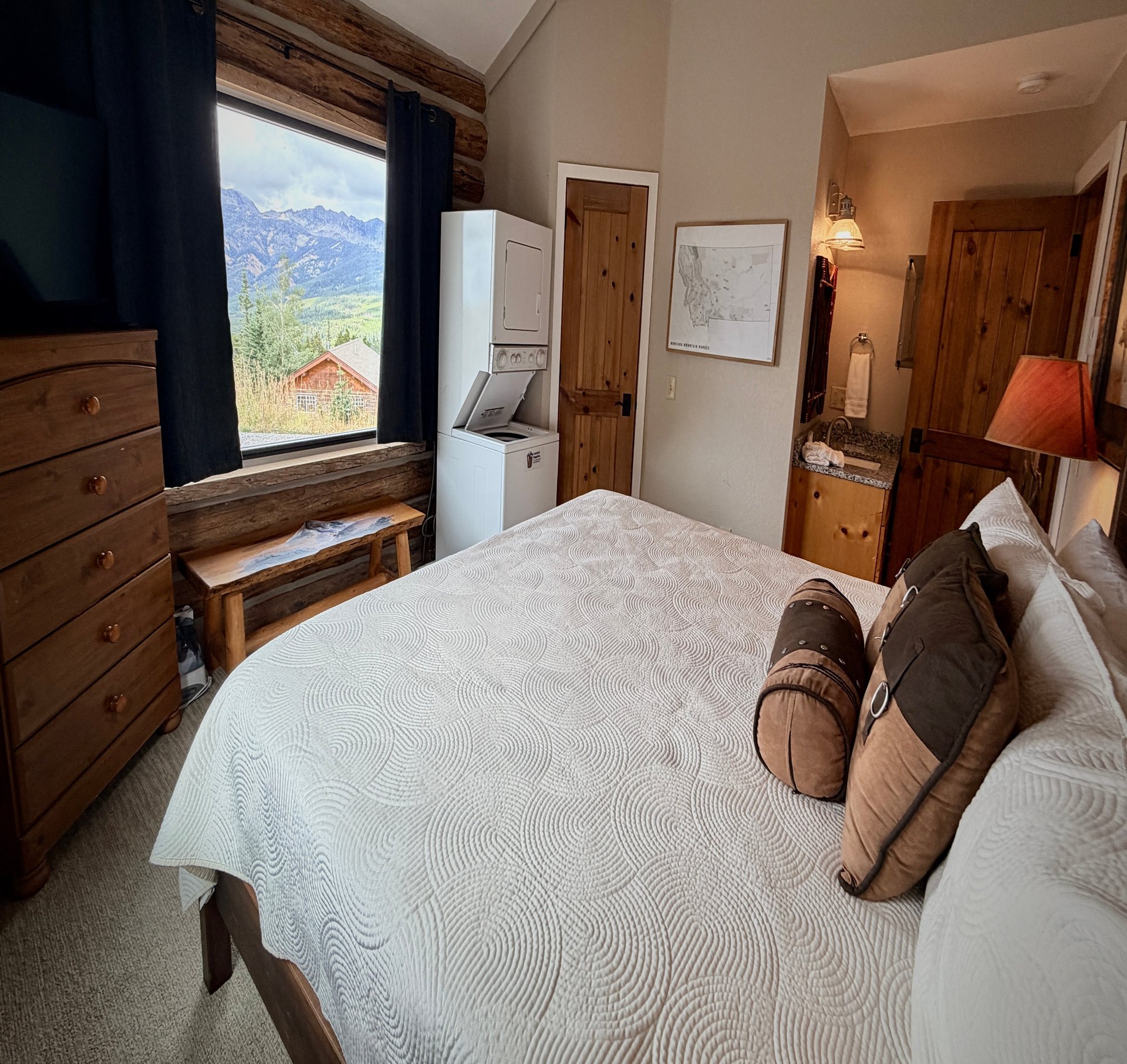 a bed with pillows and a window