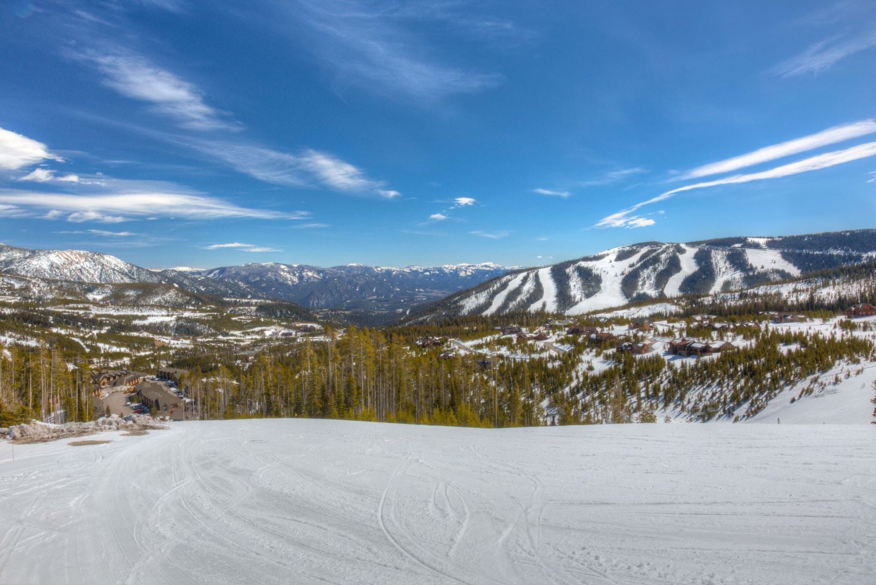a snowy landscape with trees and mountains