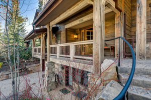 Private home main entrance with attractive decks along the front side of the house