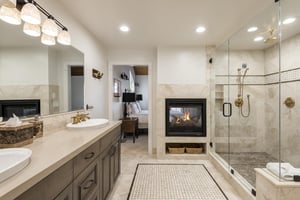 Ensuite main bathroom with dual facing fireplace