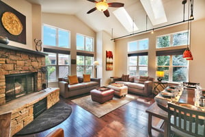 Expansive living room and dining room with track lighting and abundant natural light with two window walls