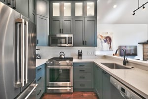 Fully equipped kitchen with French door refrigerator, gas range, and stainless steel appliances