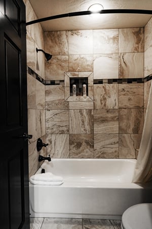 Showertub combo in the full guest bathroom with tile work