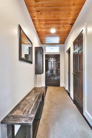 Woodside Haus entryway with wooden bench and carpet runner