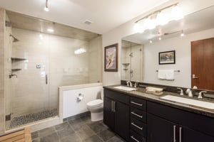 34 hallway bathroom with walk in glass paneled shower, slate tiles, double vanity