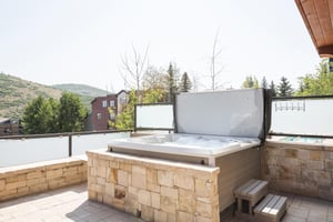 Private hot tub with flagstone wall, convenient steps to access jacuzzi