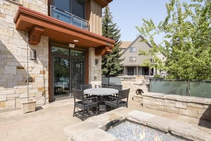 Outdoor gas fireplace and patio dining table with chairs