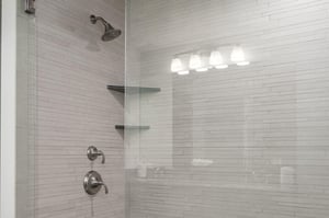 Tiled shower with glass panel doors