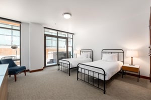 Twin beds with vertical bar metal bedframes, can be converted to a king with advance notice