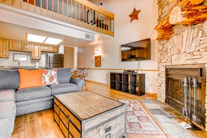 Cozy open floor plan large screen TV  ParkCityLodging_PowderPointe303B_LivingRoom