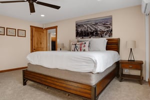 King bed with large picture window overlooking the resort plaza