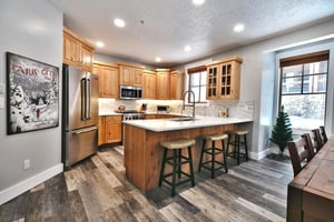 Hardwood floors in the fully equipped kitchen, kitchen has breakfast bar overlooking the living room