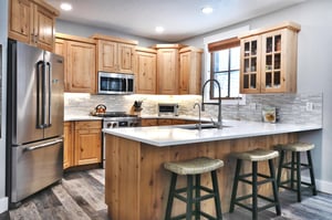 Additional seating for 3 at the kitchen breakfast bar wicker and wooden backless stools