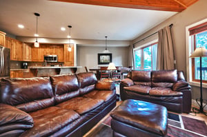 Living room with kitchen and dining room in the background