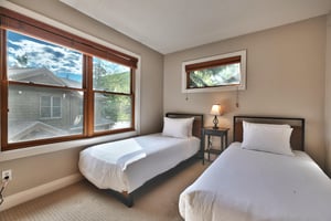 Guest bedroom with two twin beds and large picture window