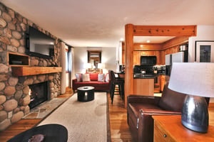 Living room features a red fabric couch, leather recliners and flat screen TV