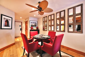 Dining area features a round table with seating for 4