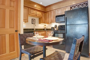 The kitchen features beautiful wood cabinets and green granite countertops