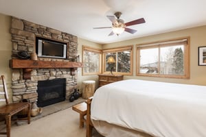 Main bedroom with queensized bed and gas fireplace