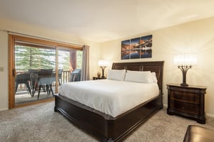 Main bedroom features a kingsized bed with access to the private patio