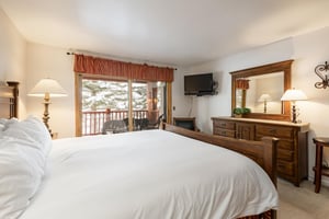 Main bedroom with wallmounted flat screen TV