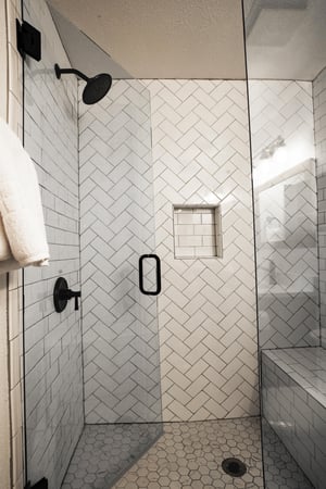 Ensuite main bathroom includes a modern walkin tiled shower with a bench