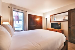 The guest bedroom features a comfortable queensized bed and flat screen TV on the dresser