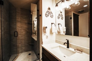 The shared second guest bathroom, also beautifully remodeled, includes a modern walkin tiled shower, quartzite countertops and has plenty of storage.