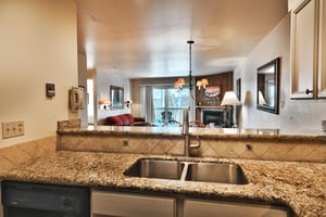 The kitchen opens into the dining area and living room to keep the conversation flowing