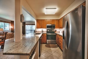 Kitchen with french door stainless steel refrigerator, chrome stove and granite countertops
