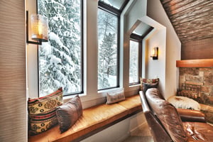 Cozy up in the window alcove overlooking snowy pine rees