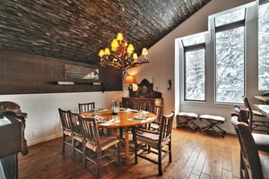 Intimate dining area with solid wooden dining table and log wood dining chairs