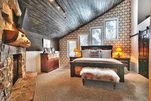 Main bedroom suite with luxurious king bed, casement windows and southwestern upholstered bedroom bench