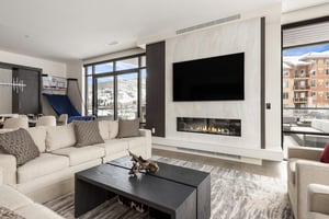 Living room with private patio access and head to head basketball shootout game for kids and adults alike