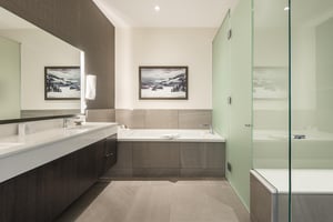 Main bathroom with tiled jetted tub, glass panel shower and frosted glass toilet enclosure