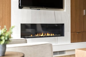 Quartz fireplace surround with gas fireplace and flat screen TV
