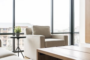 Mountain modern design, accent armchair in the living room with abundant natural light from window walls