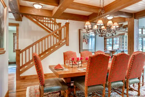 Dining room table with seating for 8 accented with traditional iron chandelier