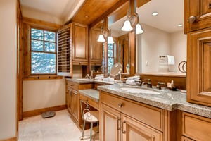 Double vanity in the main bath, multilevel granite counter tops and beautiful wooden cabinetry