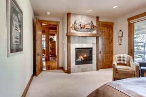 Warm ambiance in the king guest bedroom with convenient gas fireplace in slatestone hearth