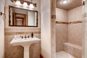 Stylish tiled bathroom in the downstairs den area