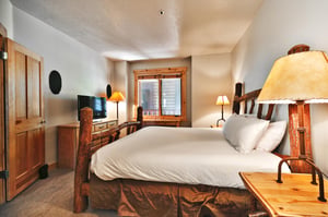 Flat screen TV and wooden dresser in the second bedroom